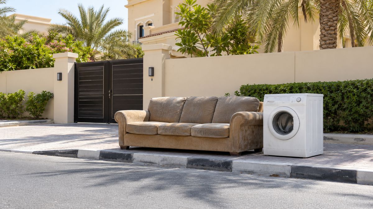 Old sofa and appliances placed on the pavement outside a Dubai villa for collection